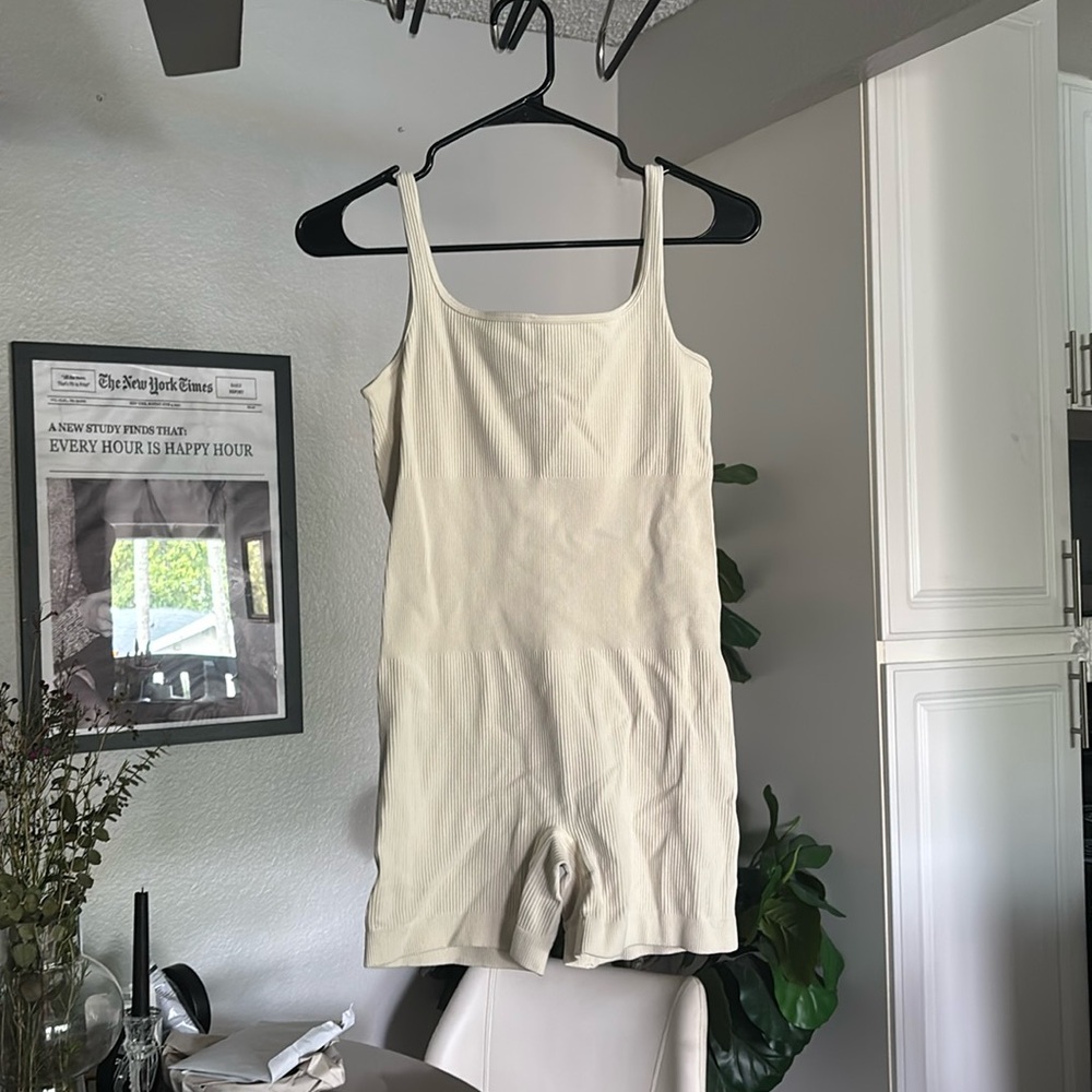 Cream, comfy, body fitting short jumper.